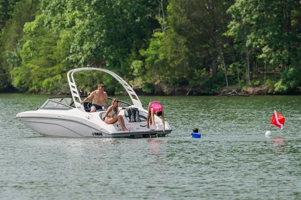 Slide: The Image of 2026 Yamaha Boats 195S on a lake with people enjoying water activities. - 6