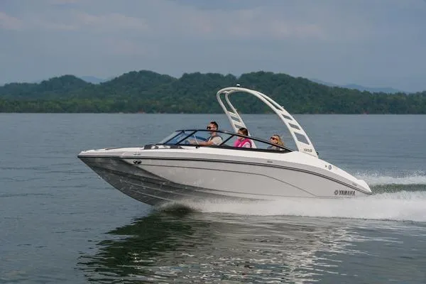 Slide: The Image of 2026 Yamaha Boats 195S cruising on a lake with passengers, scenic mountain backdrop. - 8