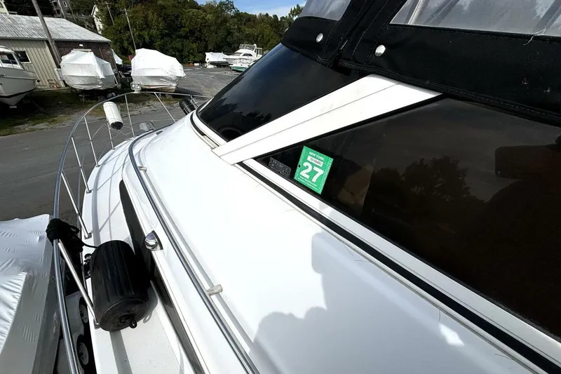 Slide: The Image of 2003 Carver 396 Motor Yacht docked, featuring sleek design and New York registration sticker. - 10