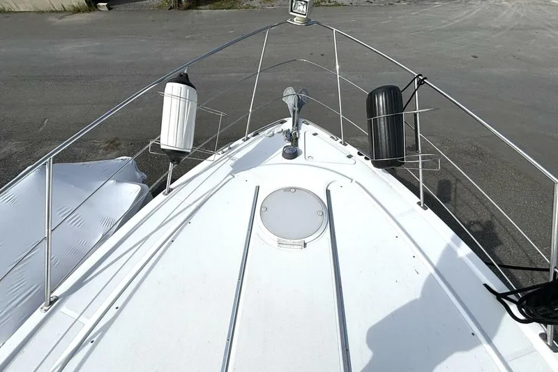 Slide: The Image of Bow view of 2003 Carver 396 Motor Yacht with fenders and anchor. - 15
