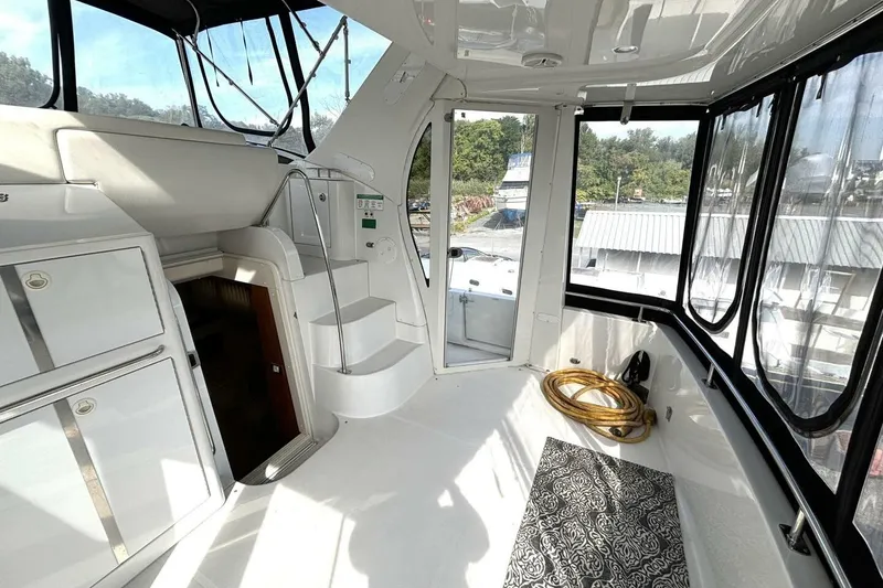 Slide: The Image of 2003 Carver 396 Motor Yacht interior with stairs, storage, and panoramic windows. - 17
