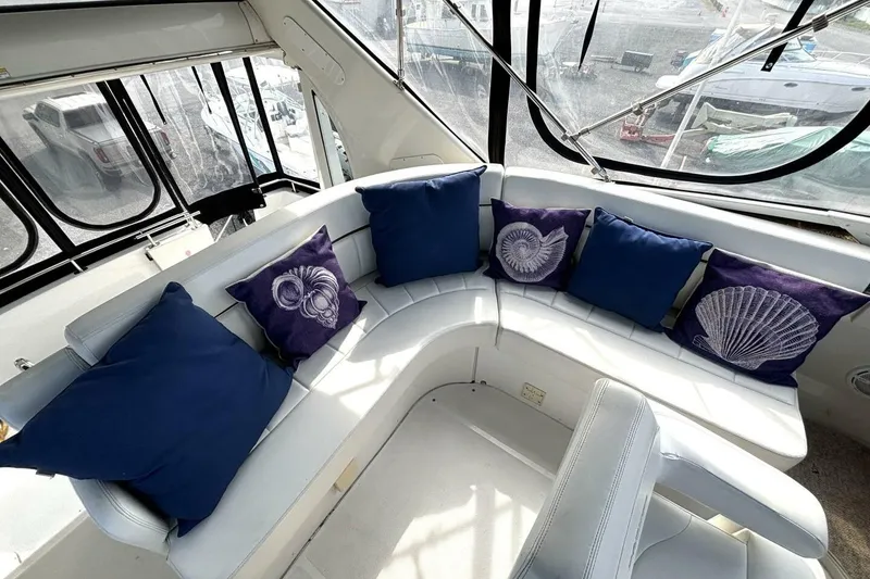 Slide: The Image of Luxurious 2003 Carver 396 Motor Yacht interior with blue and shell-themed cushions. - 21
