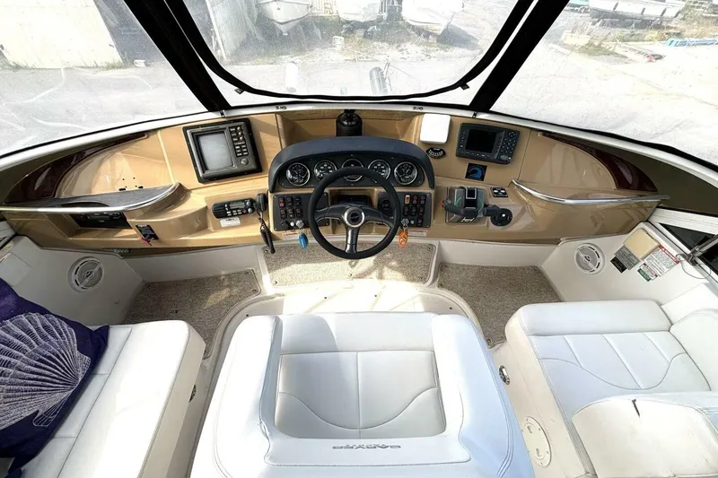 Slide: The Image of 2003 Carver 396 Motor Yacht helm with modern navigation equipment and plush seating. - 23