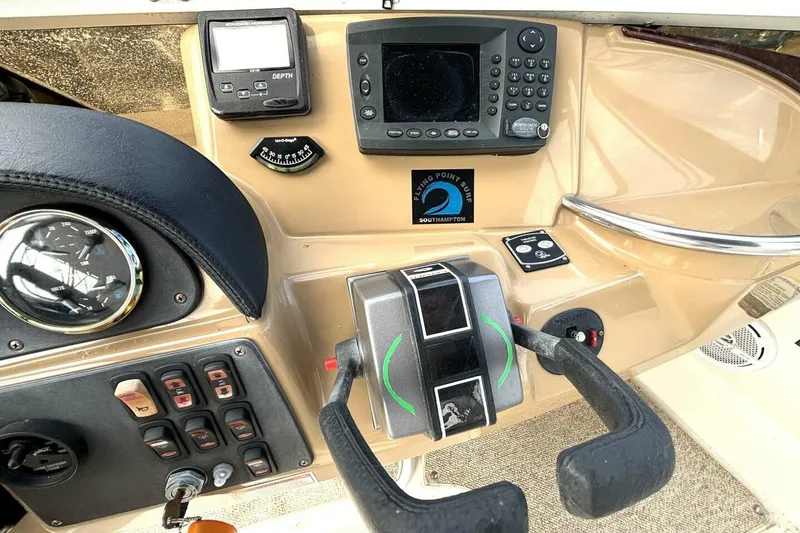 Slide: The Image of 2003 Carver 396 Motor Yacht helm with navigation controls and depth gauge. - 26