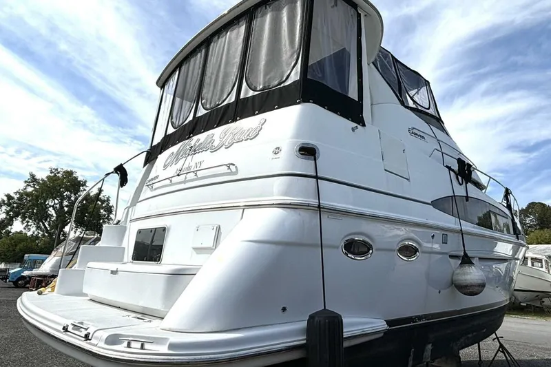 Slide: The Image of 2003 Carver 396 Motor Yacht with sleek design, docked under a blue sky. - 3