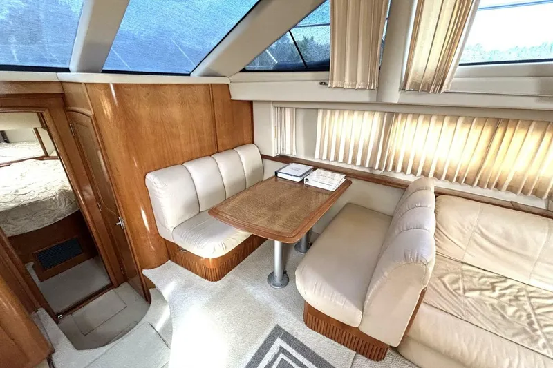 Slide: The Image of Luxurious interior of 2003 Carver 396 Motor Yacht with plush seating and wooden accents. - 33