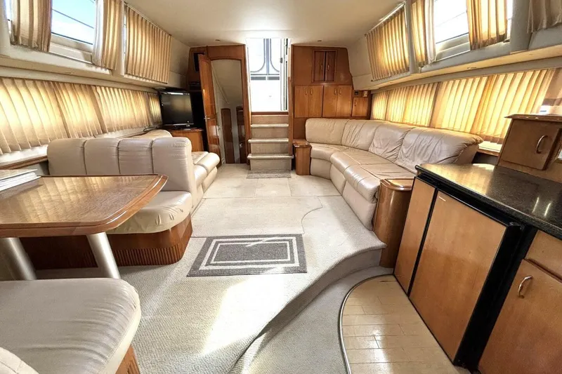 Slide: The Image of Luxurious interior of 2003 Carver 396 Motor Yacht with plush seating and elegant wood finishes. - 41
