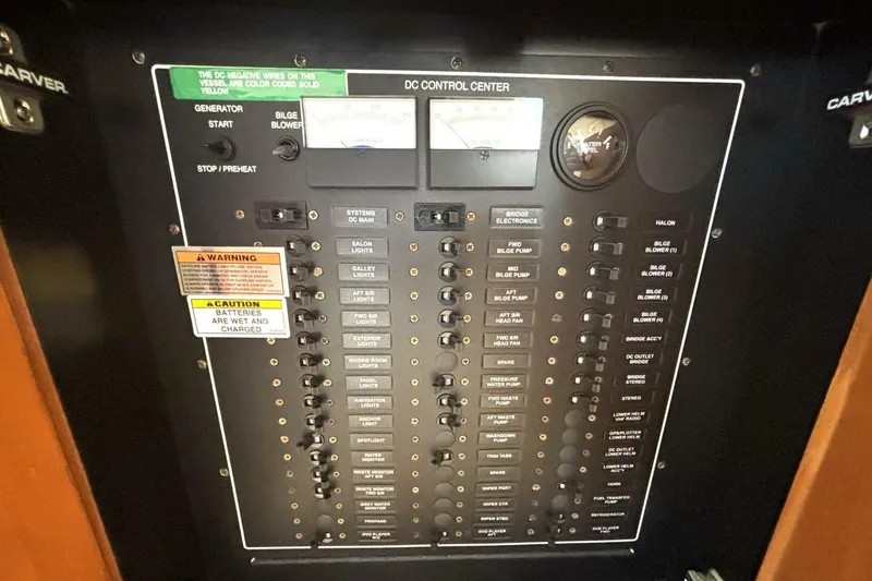 Slide: The Image of Control panel of a 2003 Carver 396 Motor Yacht with various switches and gauges. - 51