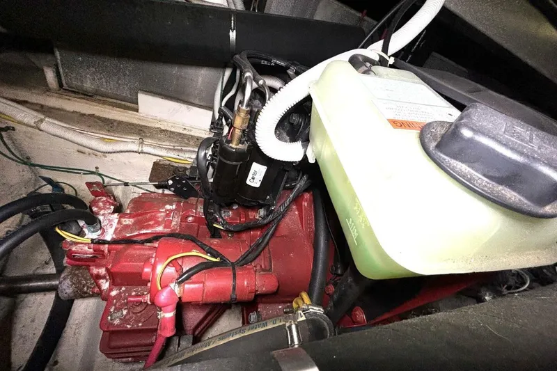 Slide: The Image of Engine compartment of 2003 Carver 396 Motor Yacht, featuring red machinery and wiring. - 54