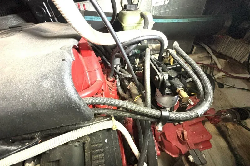 Slide: The Image of Engine compartment of a 2003 Carver 396 Motor Yacht with visible hoses and components. - 55