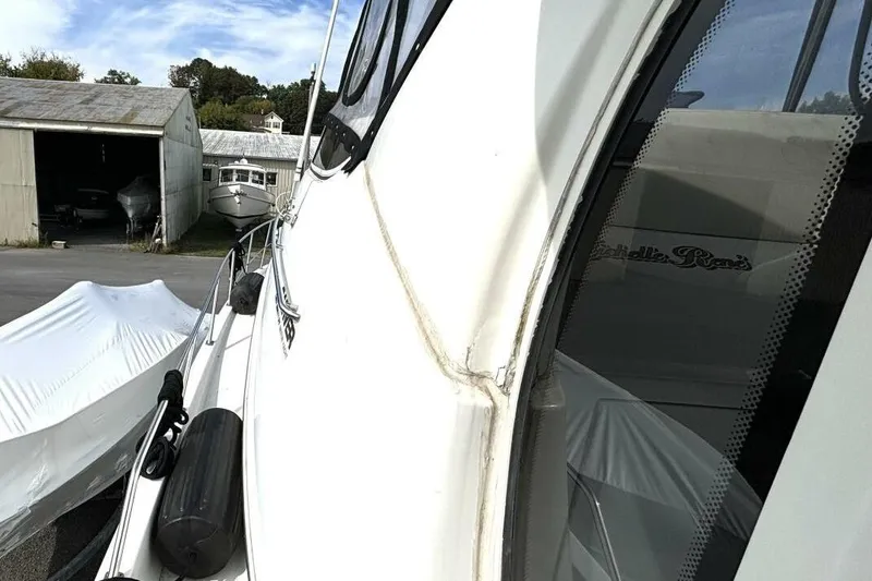 Slide: The Image of 2003 Carver 396 Motor Yacht docked near storage buildings. - 9