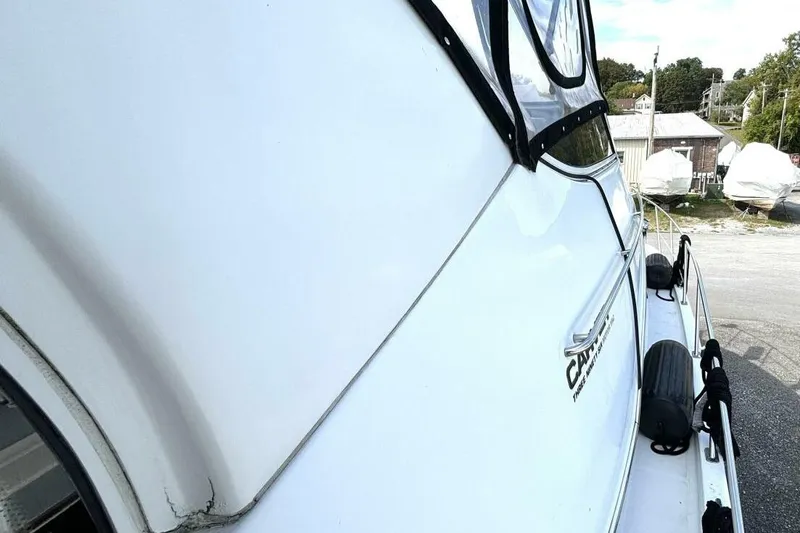 Slide: The Image of 2003 Carver 396 Motor Yacht side view, showcasing sleek design and docked setting. - 12