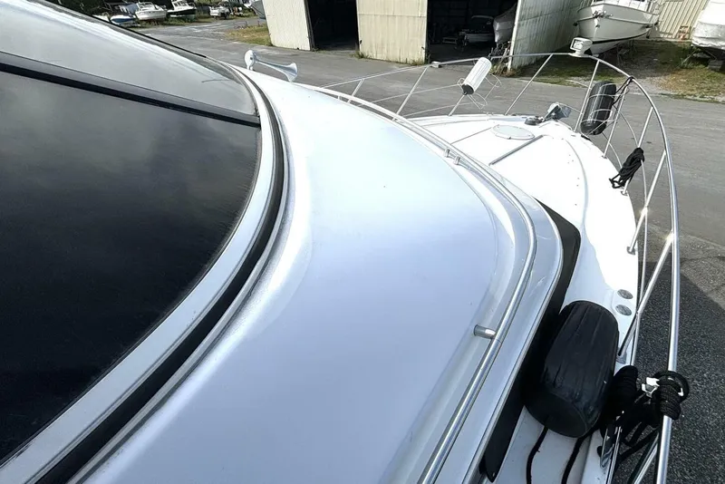 Slide: The Image of 2003 Carver 396 Motor Yacht deck view with sleek design and docked setting. - 13