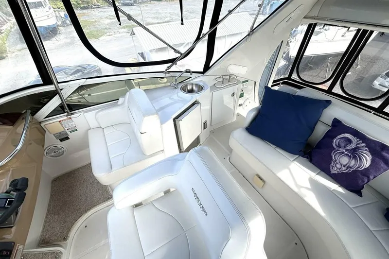 Slide: The Image of 2003 Carver 396 Motor Yacht interior with white seating and blue cushions. - 22