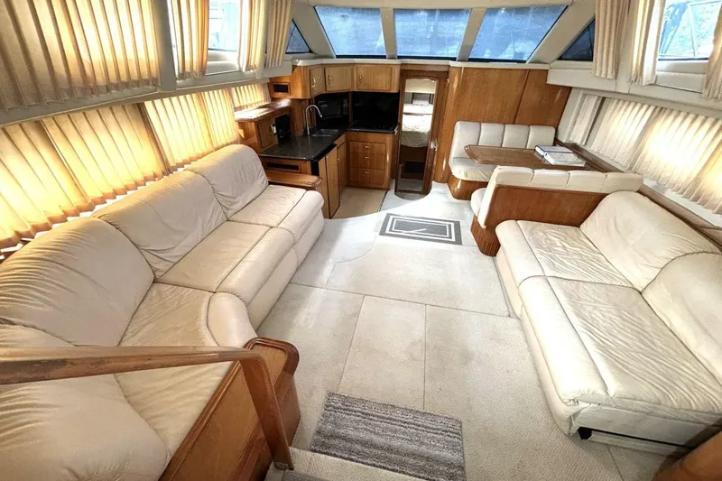 Slide: The Image of Luxurious interior of a 2003 Carver 396 Motor Yacht with plush seating and elegant wood finishes. - 29