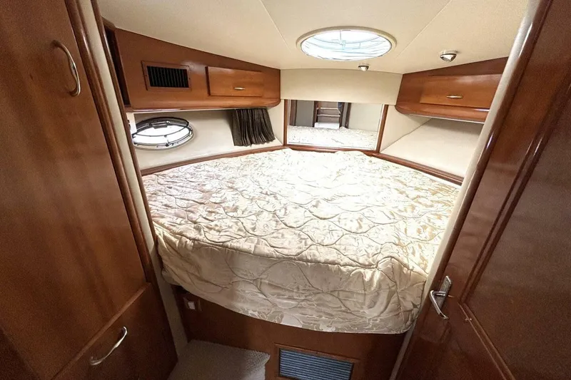 Slide: The Image of 2003 Carver 396 Motor Yacht bedroom with cozy bed and wooden cabinetry. - 36