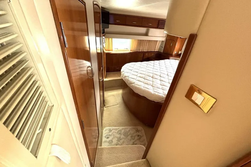 Slide: The Image of Interior of 2003 Carver 396 Motor Yacht with cozy bedroom and wooden finishes. - 42