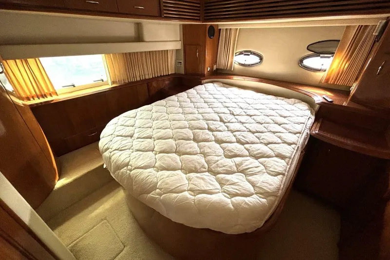 Slide: The Image of Luxurious bedroom in 2003 Carver 396 Motor Yacht with cozy bed and elegant wood finish. - 43