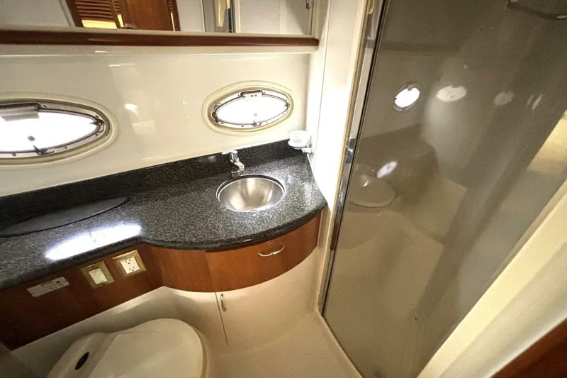 Slide: The Image of Luxurious bathroom in 2003 Carver 396 Motor Yacht with modern fixtures and porthole windows. - 46