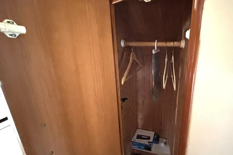 Slide: The Image of Wooden closet interior on 2003 Carver 396 Motor Yacht with hangers and storage. - 48