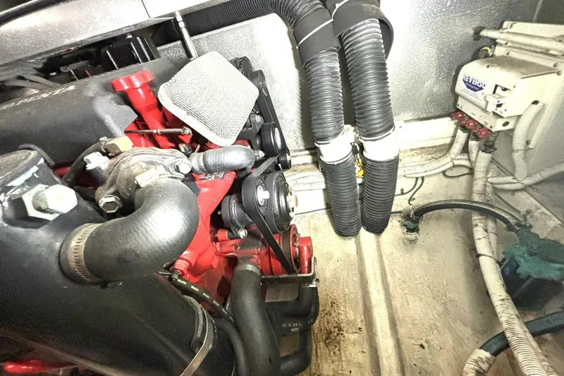 Slide: The Image of Engine compartment of 2003 Carver 396 Motor Yacht with visible hoses and components. - 53