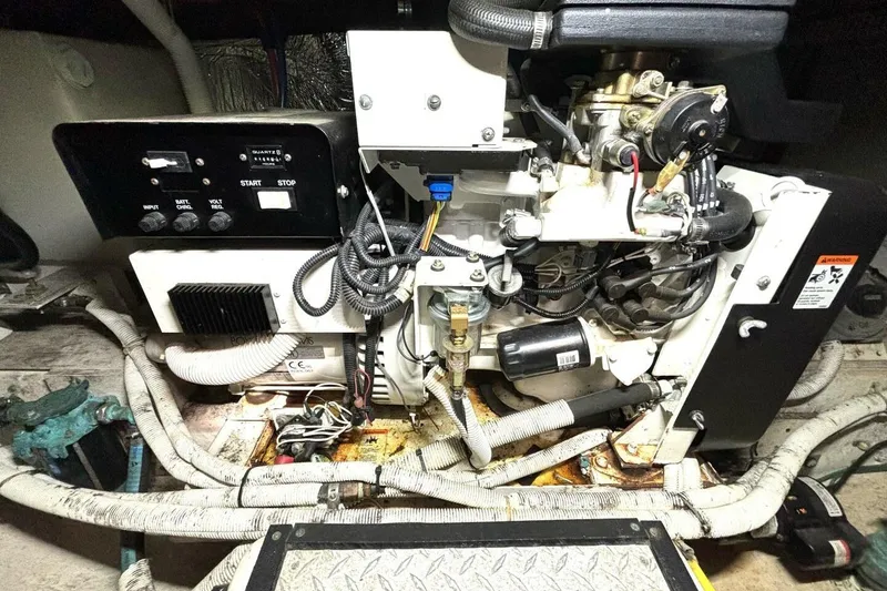 Slide: The Image of Engine compartment of a 2003 Carver 396 Motor Yacht, showcasing mechanical components and wiring. - 56