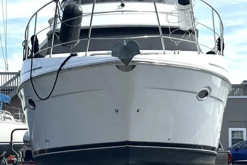 Slide: The Image of 2003 Carver 396 Motor Yacht, front view, docked with clear sky background. - 8