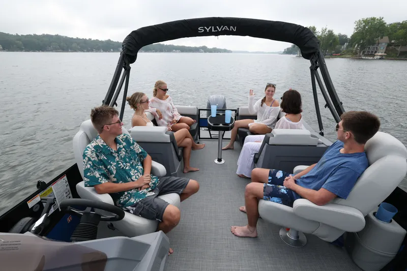 Slide: The Image of Group on Sylvan R22 LZ DH boat, 2026 model, on a lake. - 11