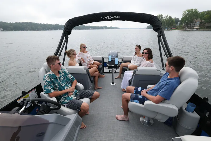 Slide: The Image of Group on Sylvan R22 LZ DH pontoon boat, 2026 model, on a lake. - 12