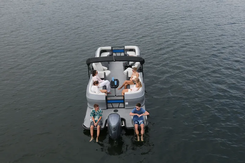 Slide: The Image of Sylvan R22 LZ DH 2026 pontoon boat on calm water with passengers. - 4