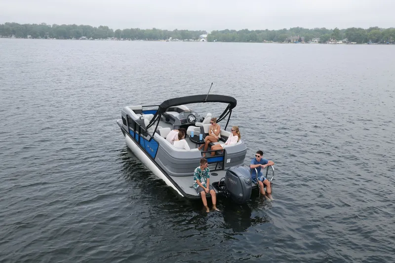 Slide: The Image of Sylvan R22 LZ DH 2026 pontoon boat on a calm lake. - 5