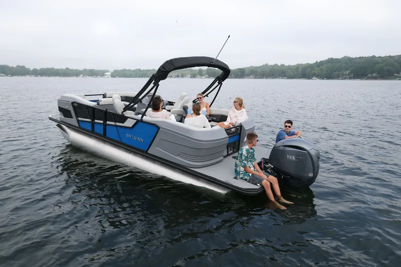 Slide: The Image of Sylvan R22 LZ DH 2026 pontoon boat on a serene lake. - 6