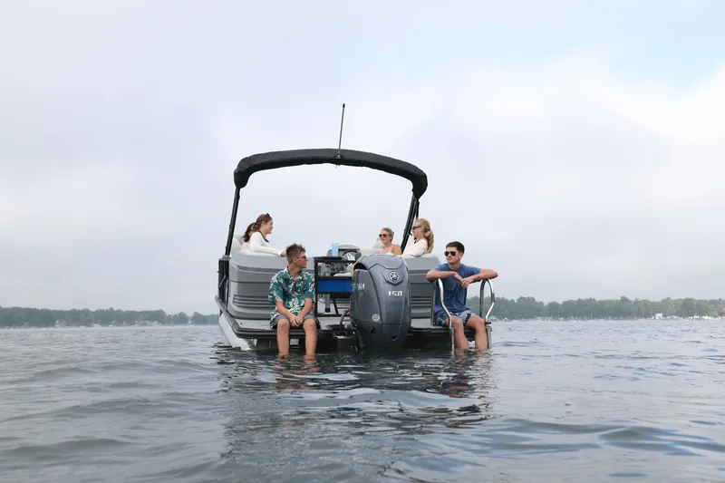 Slide: The Image of Sylvan R22 LZ DH 2026 pontoon boat on lake with passengers. - 7