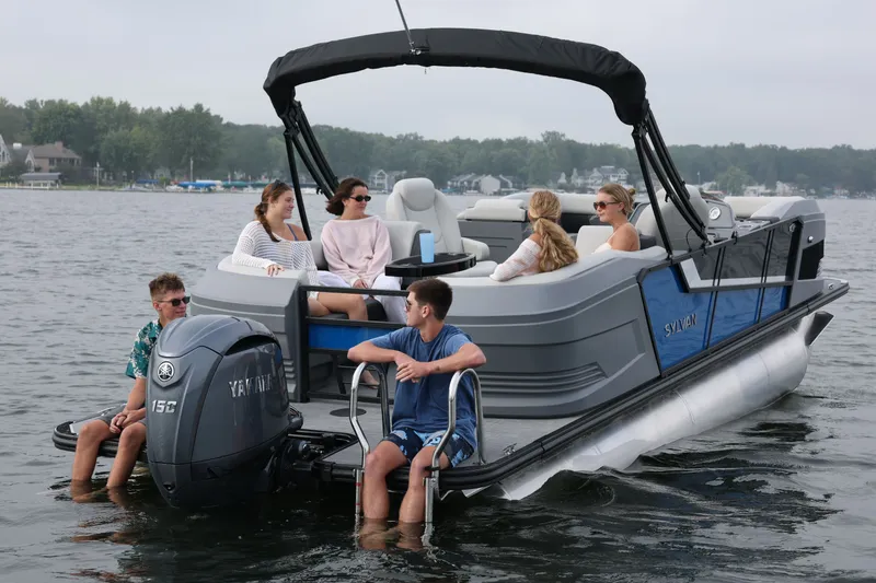 Slide: The Image of Sylvan R22 LZ DH 2026 pontoon boat on a lake with passengers. - 8