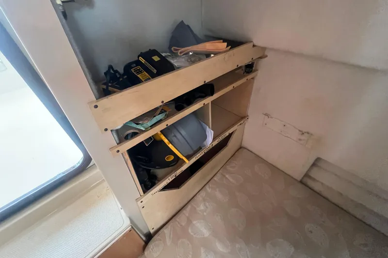 Slide: The Image of Interior storage shelves on 2017 Ranger Tugs R-27 Tug, featuring various tools and equipment. - 17