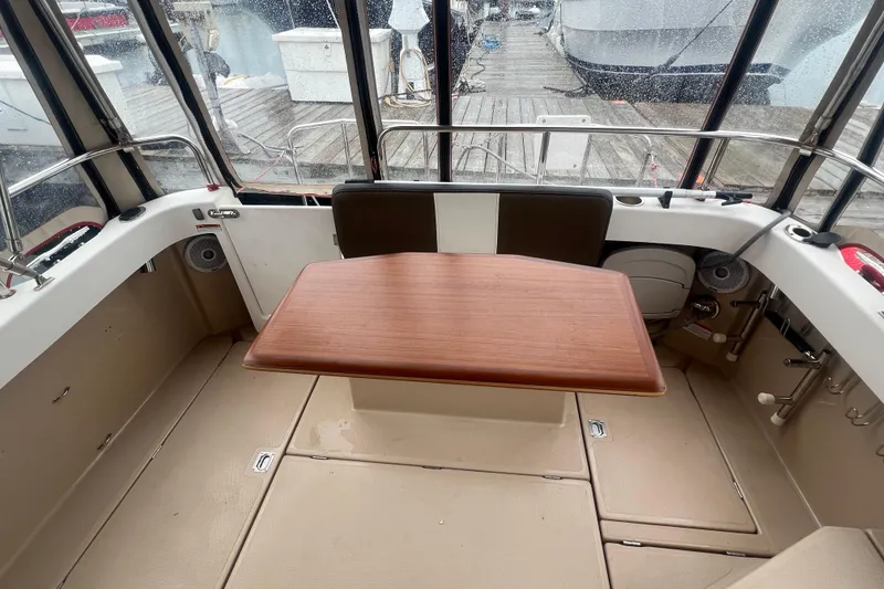 Slide: The Image of Interior of 2017 Ranger Tugs R-27 Tug with wooden table and seating area. - 20