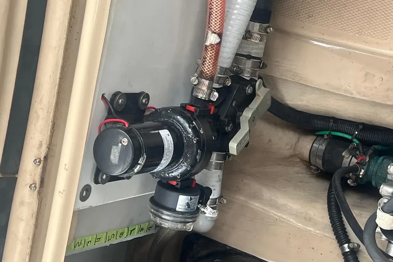 Slide: The Image of Engine compartment of a 2017 Ranger Tugs R-27 Tug, showcasing mechanical components and wiring. - 24