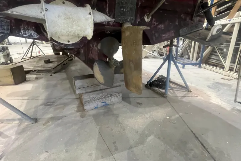 Slide: The Image of 2017 Ranger Tugs R-27 Tugboat under maintenance, showing propeller and rudder in a workshop. - 29