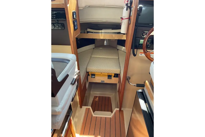 Slide: The Image of 2017 Ranger Tugs R-27 Tug interior cabin with wood accents and seating area. - 3