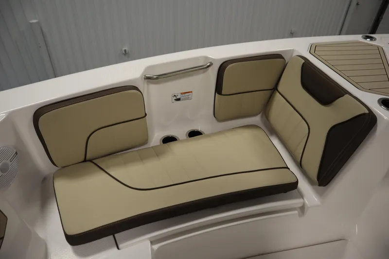 Slide: The Image of 2026 Yamaha Boats 222 FSH Sport interior seating, featuring beige and brown cushioned seats. - 14