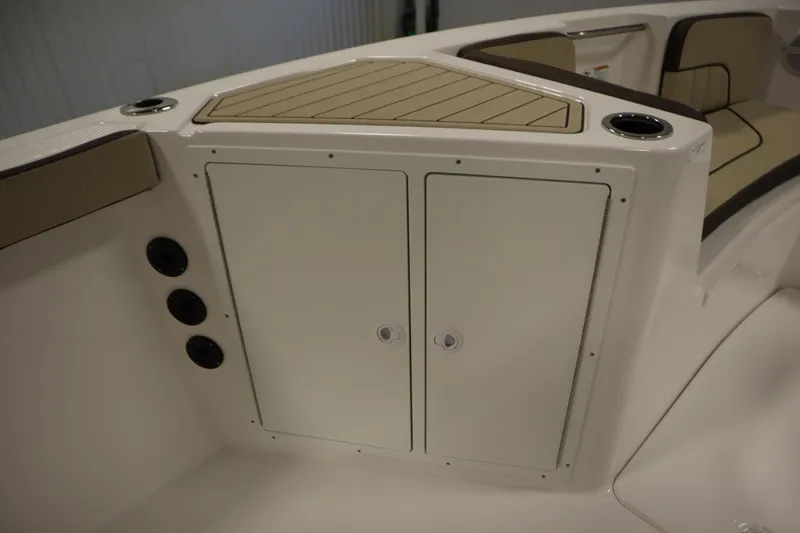 Slide: The Image of 2026 Yamaha Boats 222 FSH Sport interior storage compartment with cup holder and seating. - 20