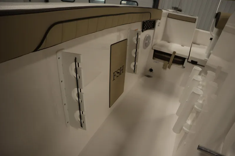 Slide: The Image of 2026 Yamaha Boats 222 FSH Sport interior with rod holders and storage compartments. - 24