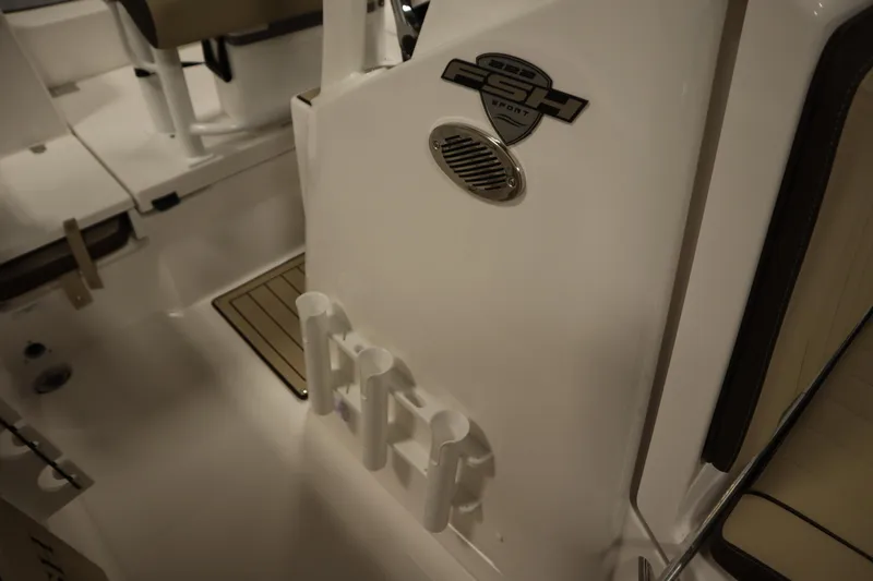 Slide: The Image of 2026 Yamaha Boats 222 FSH Sport interior with rod holders and logo detail. - 25