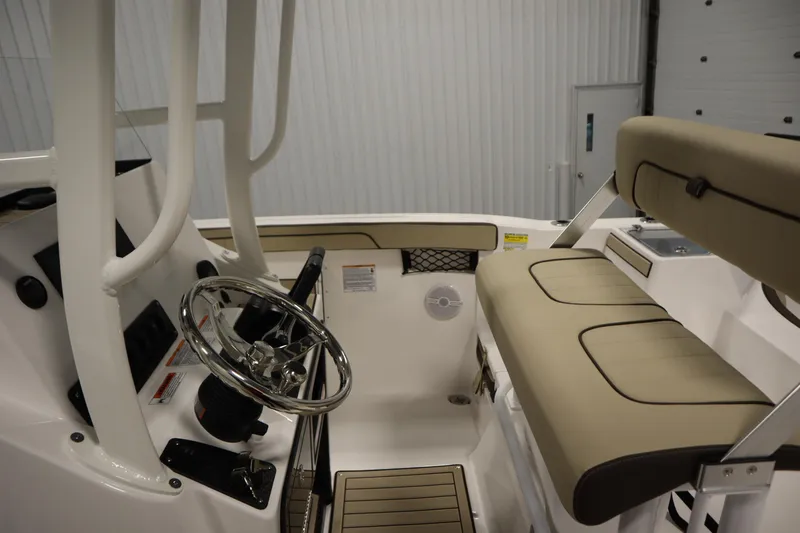 Slide: The Image of 2026 Yamaha Boats 222 FSH Sport interior with steering wheel and cushioned seating. - 26
