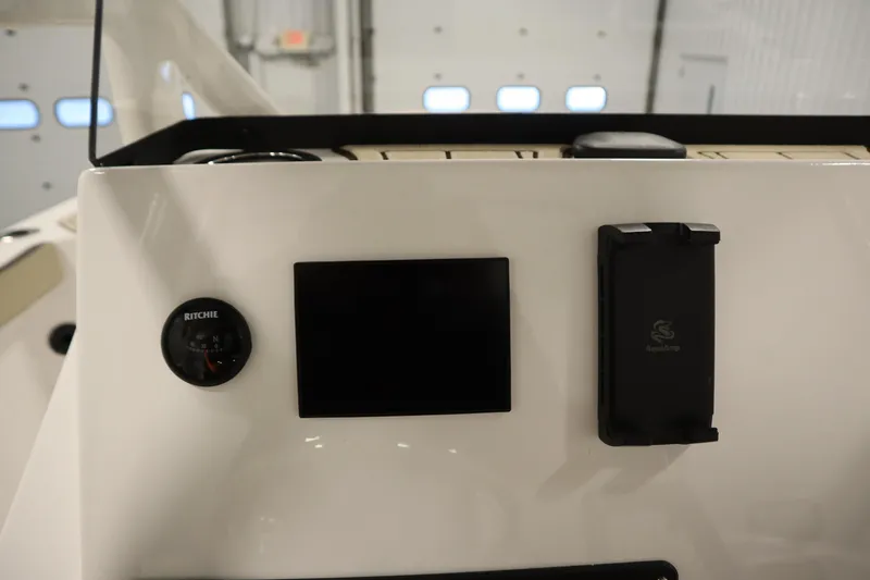 Slide: The Image of Dashboard of 2026 Yamaha Boats 222 FSH Sport with compass and device holder. - 29