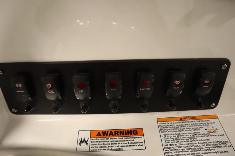 Slide: The Image of Control panel of 2026 Yamaha Boats 222 FSH Sport with labeled switches and warning labels. - 30