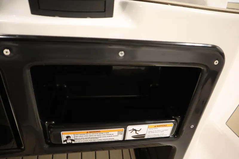 Slide: The Image of Storage compartment on 2026 Yamaha Boats 222 FSH Sport, featuring safety warnings. - 35