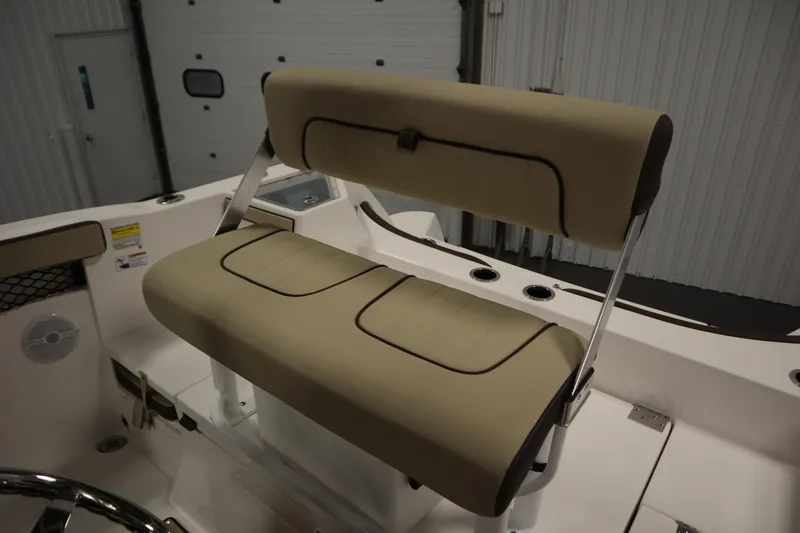 Slide: The Image of 2026 Yamaha Boats 222 FSH Sport interior with beige seating and stainless steel accents. - 36