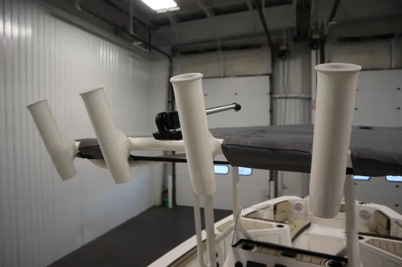 Slide: The Image of 2026 Yamaha Boats 222 FSH Sport fishing rod holders in a garage setting. - 43