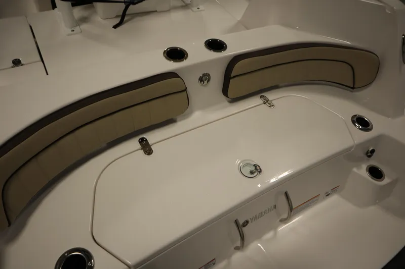 Slide: The Image of 2026 Yamaha Boats 222 FSH Sport interior seating with storage compartments. - 44